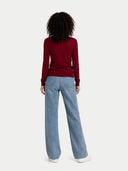 back view of person wearing a red sweater and blue jeans on a white background #color_bordeaux