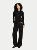 Person wearing a black outfit with a plain background #color_black