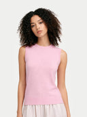 Woman wearing a pink sleeveless top against a plain background #color_almond-blossom