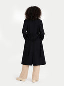 back view of a person wearing a black coat with a white background  #color_black