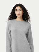 a zoomed-in shot of a woman wearing a gray dress against a white background #color_high-rise