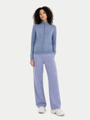 Woman wearing a blue tracksuit on a white background #color_purple-impression