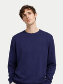 Man wearing a blue sweater on a light gray background #color_navy
