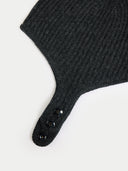 close up of a dark gray cashmere knitted aviator cap with buttons on a light gray background #color_charcoal