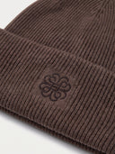 Close-up of the Women's Seamless Cashmere Ribbed Beanie in Brown, showing the turn-up cuff with the embroidered monogram and the rib knit