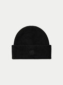 A black ribbed knit beanie hat with a folded cuff, featuring a subtle tonal embroidered logo on the front, set against a light gray background.