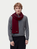 Model wearing the Cashmere Classic Knitted Scarf in Wine Red, worn around the neck