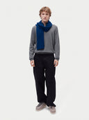Model wearing the Cashmere Classic Knitted Scarf in Deep Blue, full-length front view