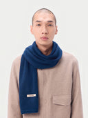 Model wearing the Cashmere Fine-Knit Long Scarf in Deep Blue, worn around the neck