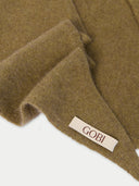 Close-up of a brown fabric with a 'Gobi' label on a white background. #color_aloe