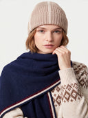 Close-up of the navy cashmere scarf at the neck, showing the soft knit and the burgundy and cream stripes.