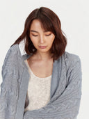 Model wearing the Cable Knit Cashmere Blanket in Light Gray, close front view