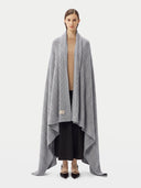 Model wrapped in the Cable Knit Cashmere Blanket in Light Gray, front view
