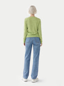 back view of Person wearing a green sweater and blue jeans on a white background #color_jade-lime