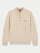 A cream-colored cable-knit sweater with a short button placket and a small embroidered logo on the chest, displayed on a light gray background.