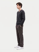 Model wearing the Cashmere V-Neck Sweater in Charcoal, three-quarter side view