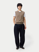 front view of Person wearing a brown vest over a white shirt with black pants on a white background #color_taupe