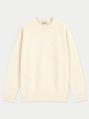 A cream-colored crew neck sweater with a tonal, raised floral pattern on the chest, displayed flat against a light gray background.