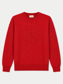 A bright red crewneck sweater with a tonal embroidered interlocking logo on the chest, displayed flat against a light gray background.