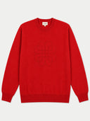 A bright red crewneck sweater with a tonal embroidered interlocking logo on the chest, displayed flat against a light gray background.