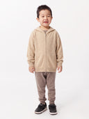 Child wearing the Unisex Seamless Zipper Hoodie in Beige, front view