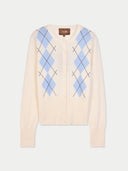 Cream-colored cardigan with blue argyle pattern on a white background #color_coconut-milk