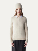 front view of a woman wearing a beige crew neck sweater matching with beanie and a black skirt. #color_birch