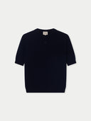 dark navy cashmere short-sleeve, crew neck sweater with a small dark brand logo at the top center on a white background #color_navy-blazer