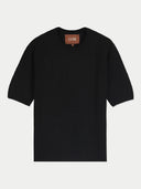 A black short-sleeve knit top with a crew neck and a brown brand label at the collar, displayed flat against a light gray background.