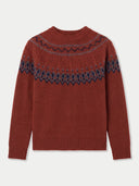 A rust-red knit sweater with a dark navy blue Fair Isle pattern across the chest and shoulders, displayed flat against a light gray background.