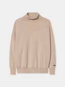 A light beige knit turtleneck sweater with ribbed collar, cuffs, and hem, displayed on a clean off-white background.