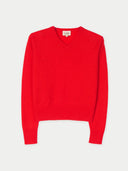 Red v-neck sweater on a light gray background #color_fiery-red