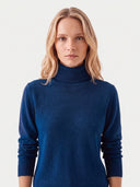 Model wearing the Cashmere Classic Turtleneck Sweater in Deep Blue, close front view