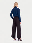 Model wearing the Cashmere Classic Turtleneck Sweater in Deep Blue, back view