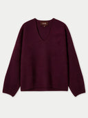 A dark burgundy knit sweater with a V-neck and long sleeves, laid flat against a light gray background. The brand name 'GOBI' is visible on the inner neck label.