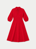 A bright red long-sleeve polo dress with a flared skirt, displayed on a clean, light gray background.