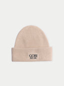 Seamless Cashmere Rib-Knit Beanie in Beige, flat lay front view with wide turn-up cuff and embroidered GOBI EST.1981 patch