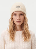 Model wearing the Cashmere Rib-Knit Beanie in Off-White, front view