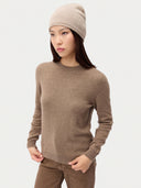 Model wearing the Women's Lightweight Seamless Cashmere Beanie in Natural Beige, full-length front view