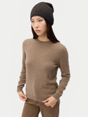 Model wearing the Women's Lightweight Seamless Cashmere Beanie in Olive Brown, full-length front view