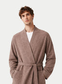 close up front view of a man wearing a brown robe against a white background #color_taupe