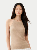 Woman wearing a beige sleeveless top against a white background #color_warm-grey