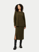 front view of a woman wearing an olive green outfit with a slit skirt on a white background #color_capulet-olive
