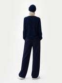 back view of Person wearing a navy outfit with a matching hat on a white background #color_navy