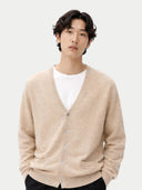Man wearing a beige cardigan over a white shirt on a light gray background #color_warm-grey