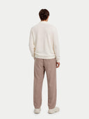 back view of a Person wearing a white sweater and beige pants on a white background #color_marshmallow