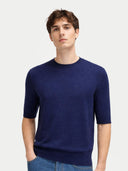 Man wearing a navy blue sweater on a light gray background #color_mood-indigo