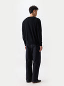 back view of a man wearing a black sweater and pants  on a white background #color_black