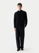 front view of a man wearing a black mock neck, zip-up cardigan and pants on a white background #color_black