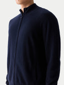 Navy blue zip-up jacket worn by a person on a light gray background #color_navy-blazer